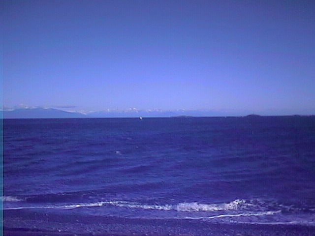 Georgia Strait. 
This is a beach near Nanaimo, British Columbia looking across the Georgia Straits to the Coast Mountains on the mainland. The islands in the middle ground to the right are called the 'Five Fingers'